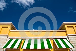 Green and white rooftop on blue sky