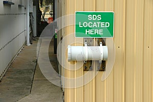 Green and white SDS Located Here sign photo