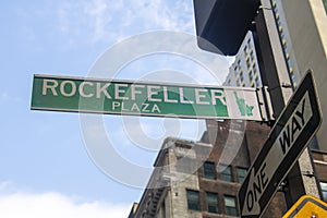 Green and white street sign Rockefeller Plaza in midtown New York
