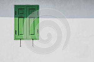 Green window on a white wall.