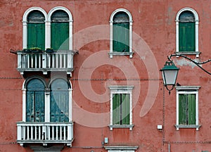 Green windows and earthy red wall