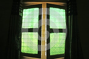 Green windows from old vintage glass with floral or geometric pa