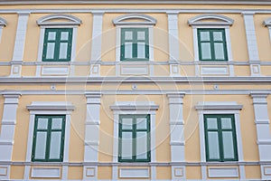 Green Windows on Yellow Vintage wall.