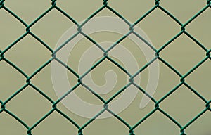 Green Wire Fence isolated on Brown Background, Horizontal