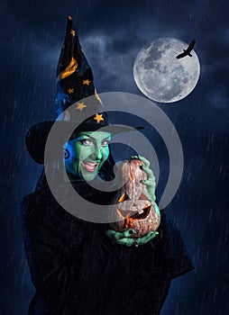 Green witch with pumpkin