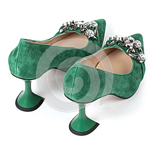 Green women& x27;s suede shoes with high heels with a beige insole decorated with shiny crystals on the front on a white