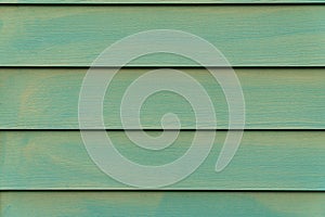 Green wooden background. Pastel mint color background. Horizontal boards. Wood texture.