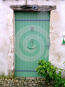 Green wooden door in a seaside village.