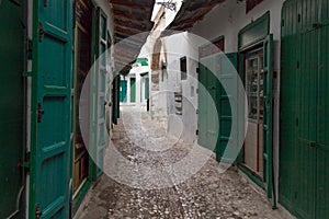 Green wooden doors of the old stores in Tetouan Medina quarter in Northern Morocco. A medina is typically walled, with many narrow