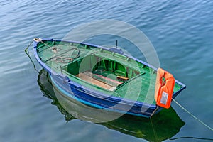 Green wooden fishing boat moored