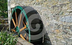 Green wooden and metal water wheel at the Mill on the Fleet at Gatehouse