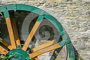 Green wooden and metal water wheel at the Mill on the Fleet at Gatehouse