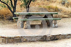 Green wooden park bench used for picnics and camping in a national park in a wilderness reserve recreation area