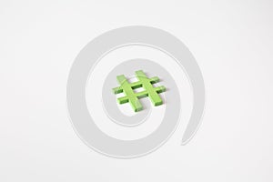 Green wooden symbol Hashtag `#` on white background