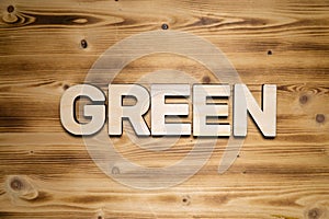 GREEN word made of wooden block letters on wooden board