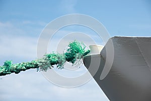 Green worn anchor rope on ship bow