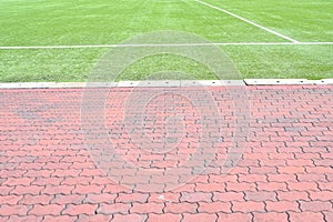 green yard and red block texture background, area for activity sport