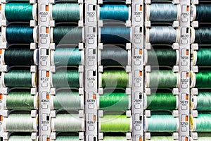 Green yarn. Colored spools of sewing thread