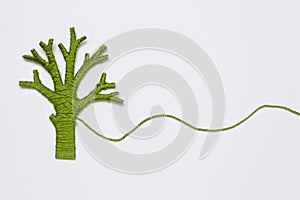 Green yarn tree isolated on white.