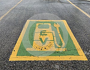 Green and yellow electric car parking symbol