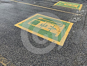 Green and yellow electric car parking symbol