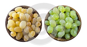 Green and yellow grapes Kishmish. Top view. Grapes in a wooden bowl isolated on white background. Vegetarian or healthy eating. To