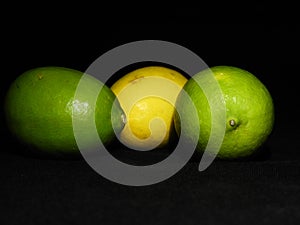 Green and yellow lemon on dark background, can be used commercially