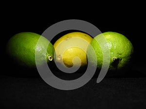 3 Green and yellow lemon on dark background, can be used commercially photo