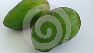 Green and yellow mangoes in summer