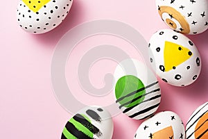 Green, yellow, orange painted easter eggs on pink background