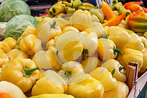 green yellow orange red bell pepper paprika on a farmer's market