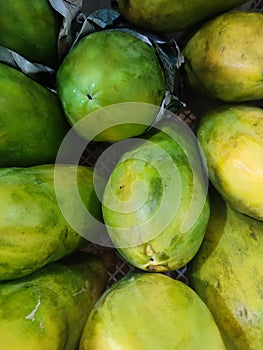 green and yellow papaya fruit neatly arranged