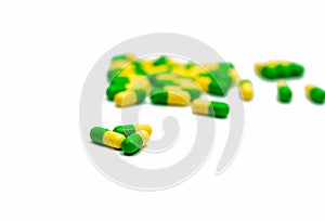 Green, yellow tramadol capsule pills on blurred capsule pills ba