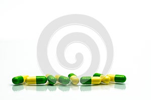 Green, yellow tramadol capsule pills on white background with sh