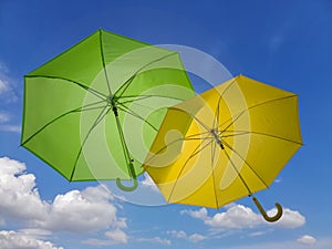 Green and Yellow Umbrella on blue sky background.