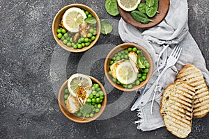 Green young peas, cheese haloumi, lemon. orange salad with slices of bread. Top View