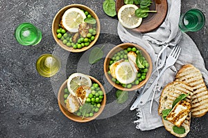 Green young peas, cheese haloumi, lemon. orange salad with slices of bread. Top View