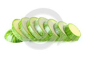 Green zucchini sliced in round slices isolated.