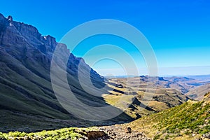 Greenery in Sani pass under blue sky near kingdom of Lesotho Sou