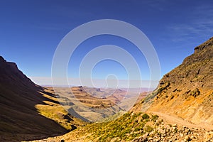 Greenery in Sani pass under blue sky near kingdom of Lesotho Sou