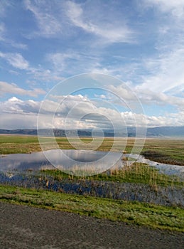 Greenfield, clouds, blue sky, mountains, waterpool, grass, steppe, road,