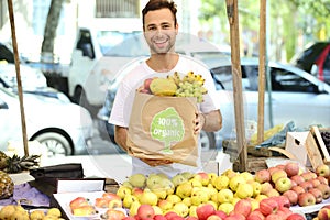 Greengrocer selling organic certified fruits.