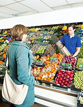 Greengrocer serving a customer