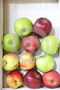 Greengrocers discount price. Pile of apples on market counter