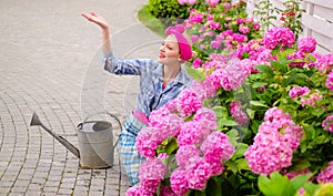 Greenhouse flowers. Flower care and watering. soils and fertilizers. woman care of flowers in garden. happy woman