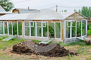 Greenhouse and heap of manure