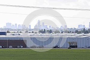 Greenhouses for vegatables in agriculture area with Rotterdam Skyline on background