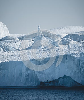 Greenland. The biggest glacier on a planet Jakobshavn. Huge icebergs of different forms in the gulf. Studying of a