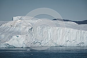 Greenland. The biggest glacier on a planet Jakobshavn. Huge icebergs of different forms in the gulf. Studying of a