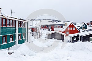 Greenlandic Inuit houses among covered in snow a suburb of arct